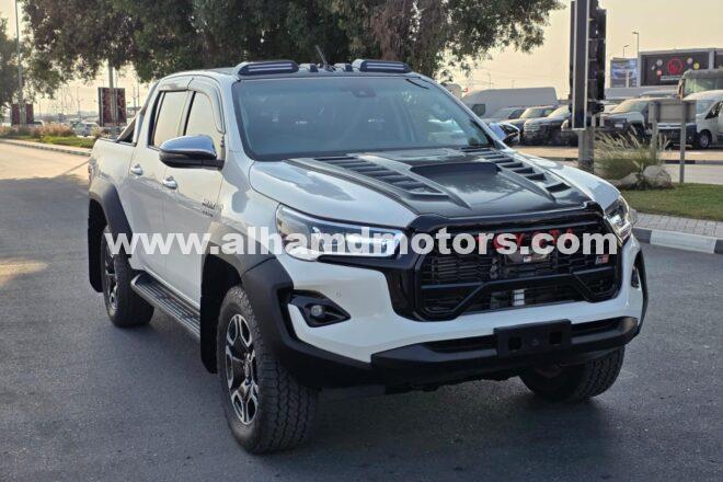 Buy the 2021 Toyota Hilux Pickup, facelifted to 2024 model, 4WD Diesel, Automatic Transmission, Right-Hand Drive, 16,700 km. White exterior, leather seats, alloy wheels, and premium features at Al-Hamd Motors.
