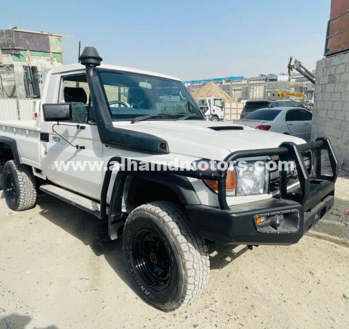 Buy the 2012 Toyota Land Cruiser Pickup, Single Cabin, 4WD Diesel, Manual Transmission, Right-Hand Drive, 37,500 km. White color with leather seats and Australian specs, available at Al-Hamd Motors.
